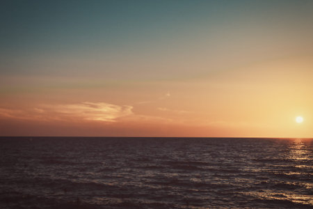 Orange sunset sky. The sea horizon. The sea line. Nature multicolored background.の写真素材