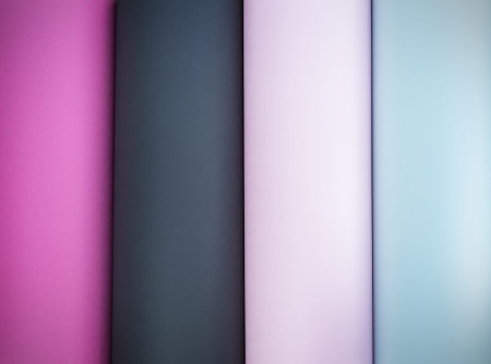 Multicolored striped paper background. Fuchsia black pink and blue stripes.