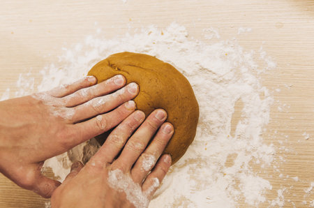 Set 3. Men's hands knead the dough. The chef prepares ginger. Christmas cookies on the table with cooking flour. Point of view.の写真素材