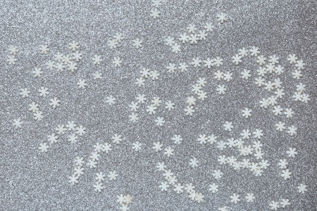 Snowflakes on a green shiny backdrop. Christmas background. Concept: flying snowの写真素材
