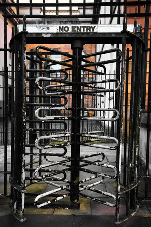 Old rusty No Entry turnstile in a street in Derry Northern Ireland