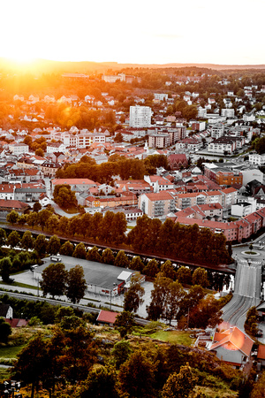 Sun setting over a traditional Swedish neighborhood. View over a beautiful city in Sweden with many houses and streets during sunset.の写真素材