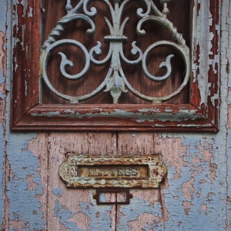 An old door and letterbox in France.の写真素材