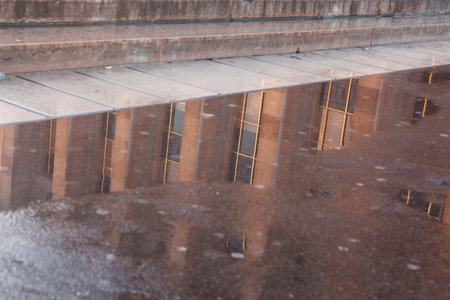A building reflecting in a puddle.の写真素材