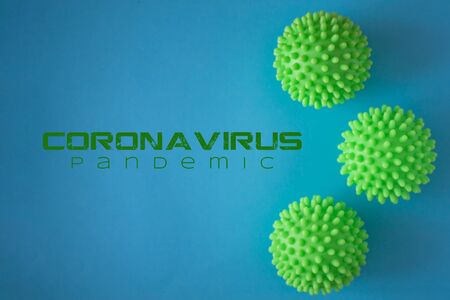 Close up of three green spiky coronavirusvirus models isolated on blue background. Pandemic desease spreading worldwide. Medical treatment of the infected people. Healthcareの写真素材