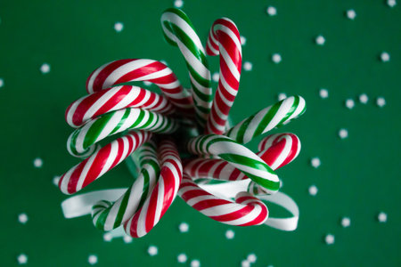 Christmas background with candy canes. Green and red sweet sticks in the glass jar. Poster, banner,...