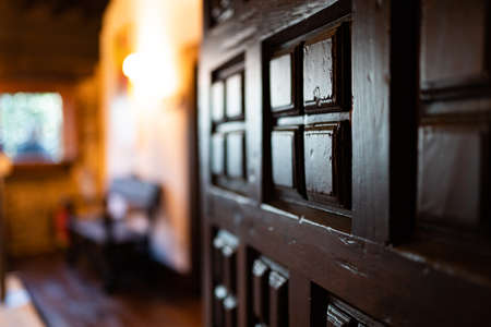 Old wooden door with a living room in the backgroundの写真素材