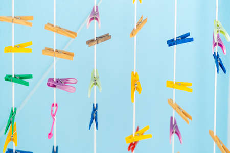 Hanging clothespins with a blue backgroundの写真素材