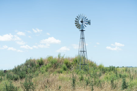 Windmill on a hillside in the summer, South Dakota.