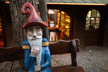 Sculpture of a gnome on a bench in a village