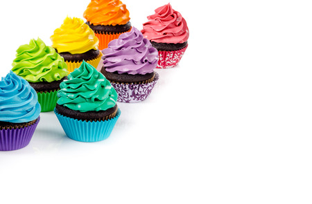 Chocolate cupcakes with colorful icing on a white background.の写真素材