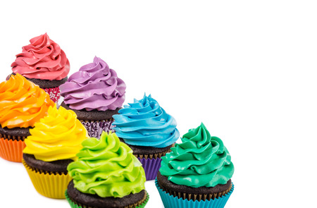 Chocolate cupcakes with colorful icing on a white background.の写真素材