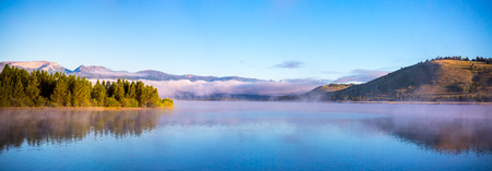 Panorama view of mist and low morning clouds at Hebgen Lake, Montana, USAの写真素材