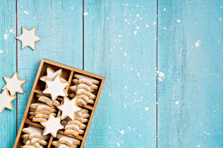 Traditional German Star Cookies in a gift box over a light blue background.  Christmas or Yom Kippur.の写真素材