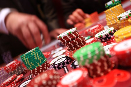 Player placing chips on a gambling table in casino.の写真素材