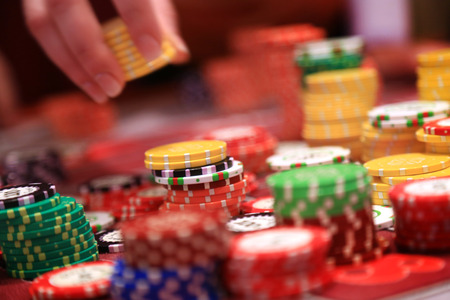 Player placing chips on a gambling table in casino.の写真素材