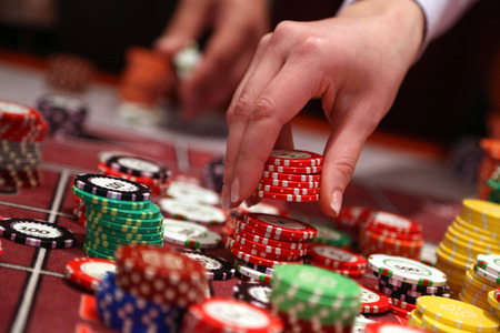 Player placing chips on a gambling table in casino.の写真素材