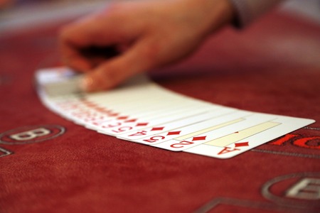 Playing cards spread on a casino tableの写真素材