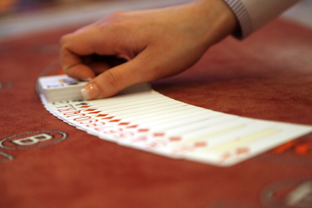 Playing cards spread on a casino tableの写真素材