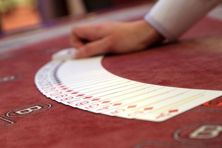 Playing cards spread on a casino tableの写真素材