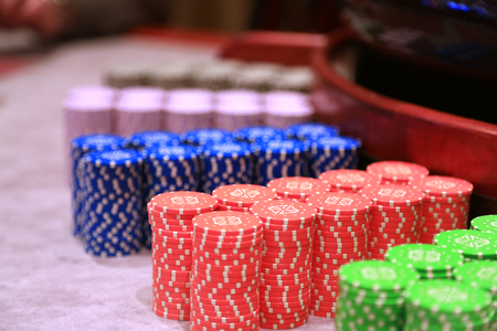 Poker chips colorful gaming pieces lie on the game table in the stackの写真素材