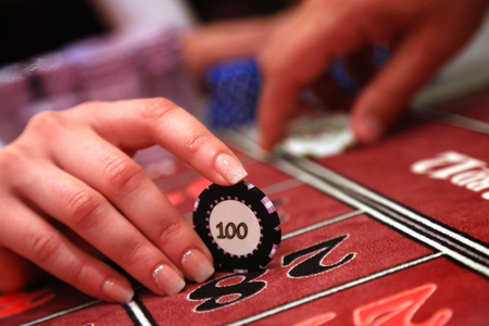 Casino player holding one chipの写真素材