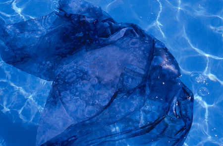 Blue fabric floating in poolの写真素材