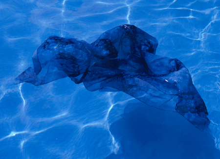 Blue fabric floating in poolの写真素材