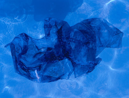 Blue fabric floating in poolの写真素材