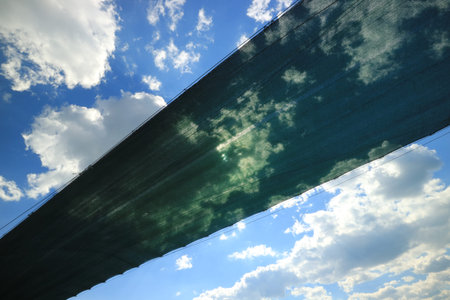 Sky seen trough stretched green fabricの写真素材