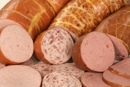 Closeup of a variety of salami with slicesの写真素材