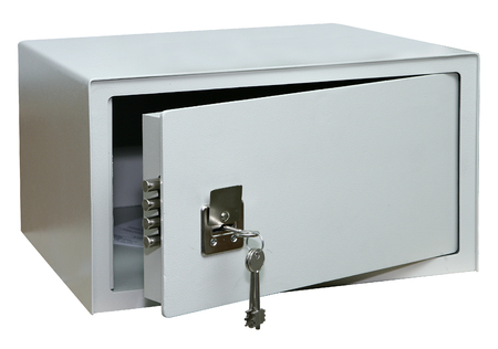 Opened metal safe with keys in the keyhole, isolatedの写真素材