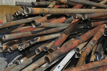 metal pipes stacked for scrapの写真素材