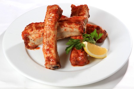 Delicious barbecued pork ribs on white plateの写真素材