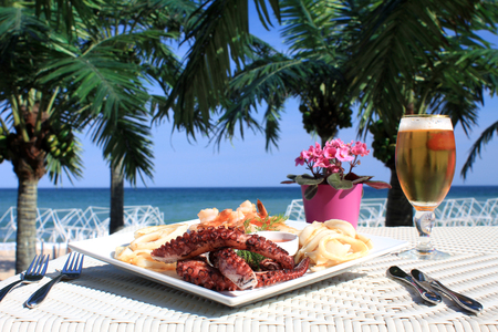octopus in dish on the beachの写真素材