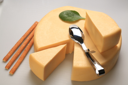 A sliced cheese wheelの写真素材