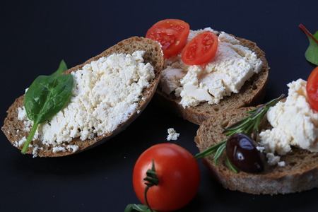 White cheese and cherry tomatoes on a slices of breadの写真素材