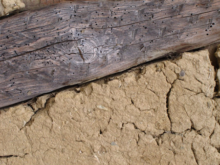 Background of wooden plank in mud, clay wall
