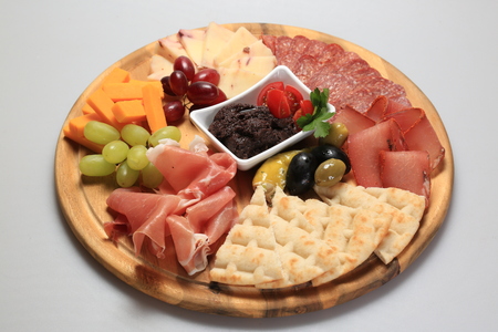 A mix of salami, cheese, ham on a plateauの写真素材