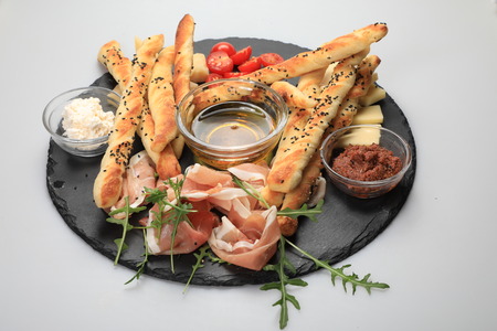 Bread with olive pate on plate with cherry toamoesの写真素材