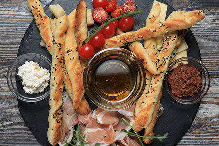 Bread with olive pate on plate with cherry toamoes