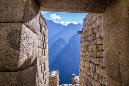 View of Andean mountains through the door of a house in the Lost Inca City Machu Picchuの写真素材
