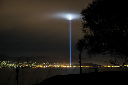 Nighttime view on Hobart, Tasmania from eastern shore shows a strobe of light during 2013 Dark Mofo Art festivalの写真素材