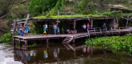 Rio Paraguay, Paraguay on August 5, 2015: Indigenous people make their way to the jetty to trade groceries and welcome their friends. The boat supplies the remote community once a week.のeditorial素材