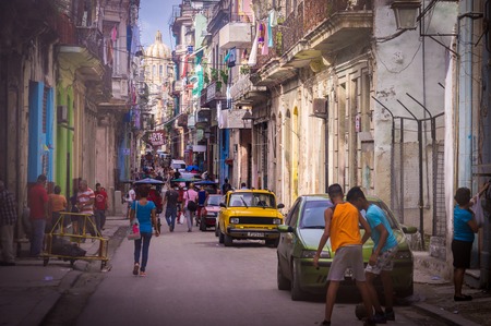 Havana, Cuba on December 22, 2015: Cuban people walking in a street in old Havana with the capitolio government building in the backgroundのeditorial素材