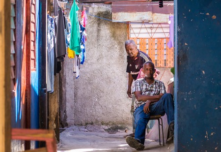 Santiago de Cuba, Cuba on January 5, 2015: Cuban people in colorful house with clothesのeditorial素材