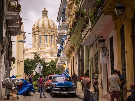 Havana, Cuba on January 14, 2016: Cuban people and oldtimer on street with view on capitol in La Habanaのeditorial素材