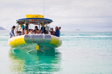 Whitehaven beach, Whitsunday Island, Queensland, Australia on August 22, 2016: Tourist speed boat in turquoise watersのeditorial素材