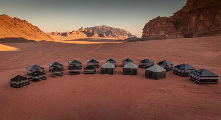 The unique experience of visiting the beautiful desert makes Wadi Rum a worthwhile stop on a visit to Jordan. Dozens of Beduin camps cater offer tourist campsites in the desert under clear skies.の写真素材