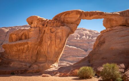 Um Fruth Rock Bridge is the most popular sight in Wadi Rum desert, Jordan. Many tourists choose to visit Wadi Rum, the most beautiful desert of Jordan.の写真素材